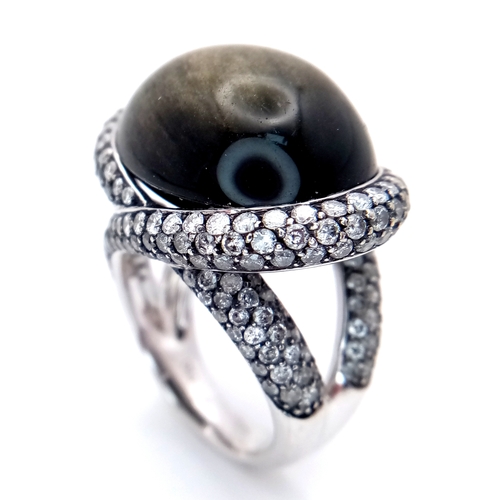 122 - A Head-Turning 18K White Gold, Diamond and Chrysoberyl (cat's eye) Ring. A large c.15ct chrysoberyl ... 