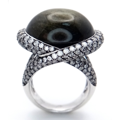 122 - A Head-Turning 18K White Gold, Diamond and Chrysoberyl (cat's eye) Ring. A large c.15ct chrysoberyl ... 