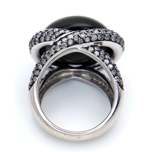 122 - A Head-Turning 18K White Gold, Diamond and Chrysoberyl (cat's eye) Ring. A large c.15ct chrysoberyl ... 