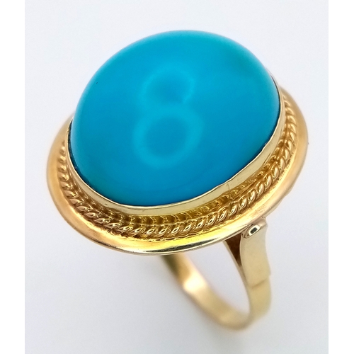 163 - An 18K Yellow Gold (tests as) Turquoise Ring. A large pale blue turquoise cabochon in a decorative s... 