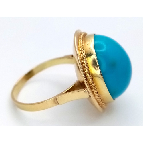 163 - An 18K Yellow Gold (tests as) Turquoise Ring. A large pale blue turquoise cabochon in a decorative s... 