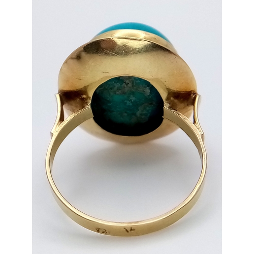163 - An 18K Yellow Gold (tests as) Turquoise Ring. A large pale blue turquoise cabochon in a decorative s... 