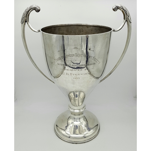 A Humongous Sterling Silver Trophy Cup. Awarded to the winner of the 'Tea Trade of London Benevolent Society' Inter Firm Lawn Tennis Doubles, 1933. It later became a golf trophy. Hallmarks for Birmingham 1932. 49cm tall. 23cm diameter. 2.75 Kilos!