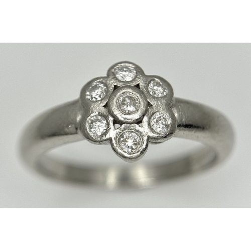166 - A PLATINUM DIAMOND SET FLOWER CLUSTER RING. TOTAL WEIGHT 6.3G. SIZE P. SPSA 2010