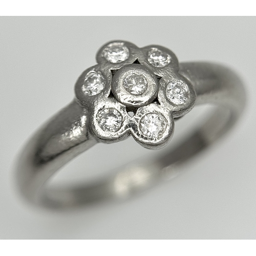 166 - A PLATINUM DIAMOND SET FLOWER CLUSTER RING. TOTAL WEIGHT 6.3G. SIZE P. SPSA 2010