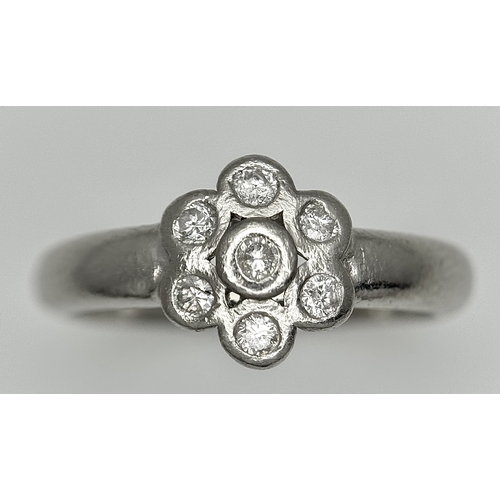 166 - A PLATINUM DIAMOND SET FLOWER CLUSTER RING. TOTAL WEIGHT 6.3G. SIZE P. SPSA 2010