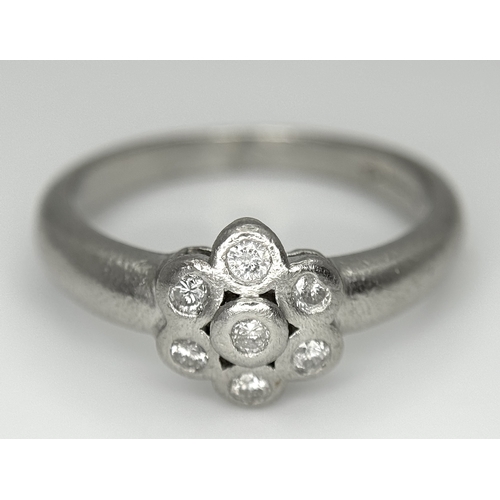 166 - A PLATINUM DIAMOND SET FLOWER CLUSTER RING. TOTAL WEIGHT 6.3G. SIZE P. SPSA 2010