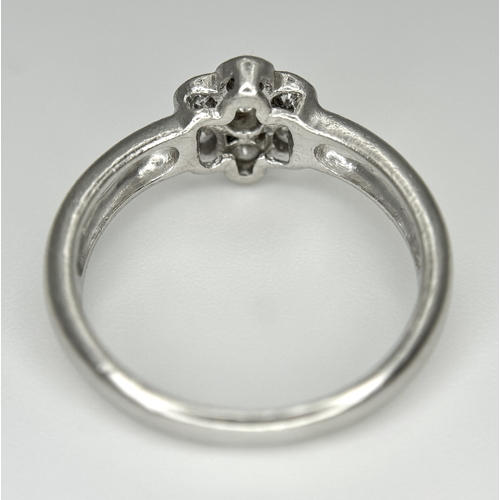 166 - A PLATINUM DIAMOND SET FLOWER CLUSTER RING. TOTAL WEIGHT 6.3G. SIZE P. SPSA 2010