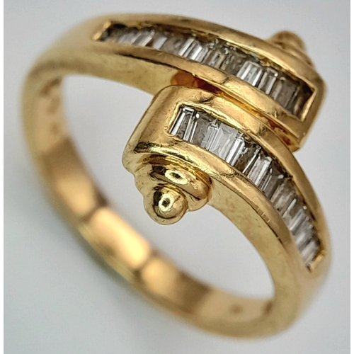113 - A 14K YELLOW GOLD FANCY BAGUETTE DIAMOND SET CROSSOVER RING. DIAMOND WEIGHT 0.25CT. TOTAL WEIGHT 3.8... 