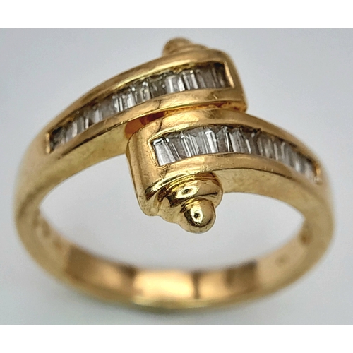 113 - A 14K YELLOW GOLD FANCY BAGUETTE DIAMOND SET CROSSOVER RING. DIAMOND WEIGHT 0.25CT. TOTAL WEIGHT 3.8... 