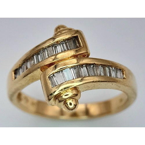 113 - A 14K YELLOW GOLD FANCY BAGUETTE DIAMOND SET CROSSOVER RING. DIAMOND WEIGHT 0.25CT. TOTAL WEIGHT 3.8... 