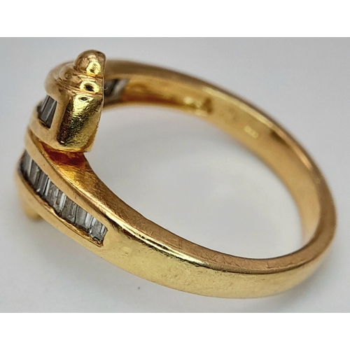 113 - A 14K YELLOW GOLD FANCY BAGUETTE DIAMOND SET CROSSOVER RING. DIAMOND WEIGHT 0.25CT. TOTAL WEIGHT 3.8... 