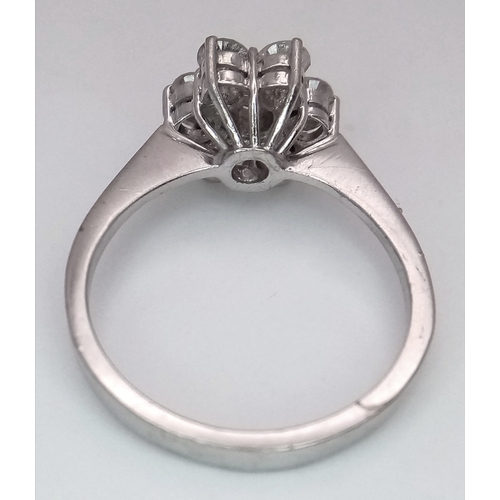 152 - A 9K WHITE GOLD DIAMOND FLORAL CLUSTER RING. DIAMOND WEIGHT 0.70CT. TOTAL WEIGHT 3G. SIZE N. SPSA 20... 