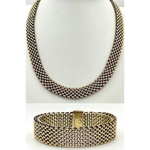 87 - A Glamourous Vintage 9K Yellow Gold Necklace and Bracelet Set. Intricate curved links create a stunn... 