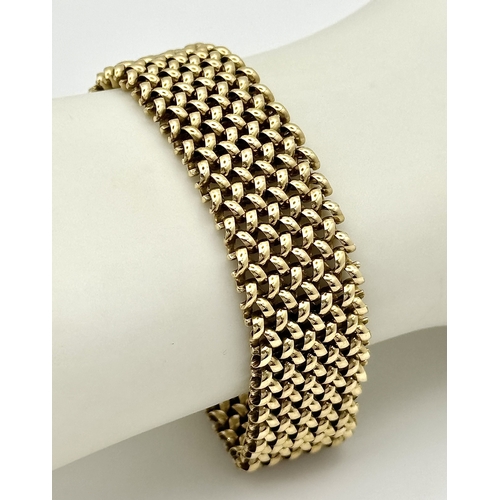 87 - A Glamourous Vintage 9K Yellow Gold Necklace and Bracelet Set. Intricate curved links create a stunn... 