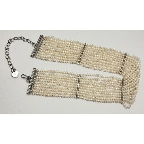 112 - Impressive 10 STRAND, PEARL and SILVER CHOKER NECKLACE. Consisting 10 rows of lab seed pearls with S... 