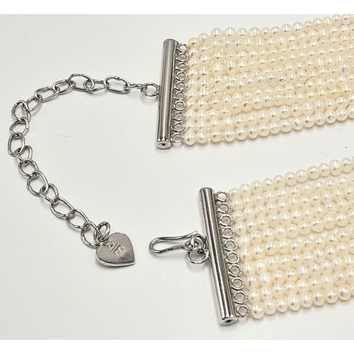 112 - Impressive 10 STRAND, PEARL and SILVER CHOKER NECKLACE. Consisting 10 rows of lab seed pearls with S... 