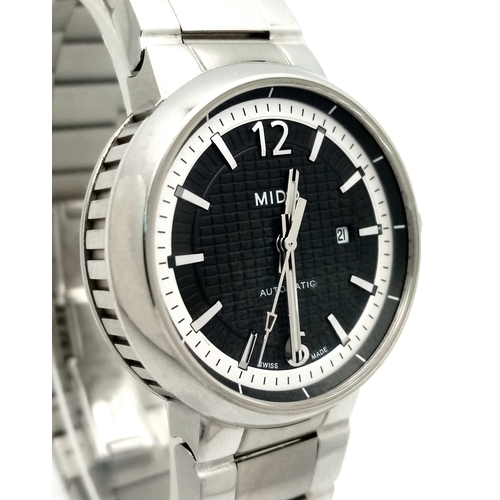 181 - A Mido Automatic Ladies Watch. Model M015230A. Stainless steel bracelet and case - 32mm. Black textu... 