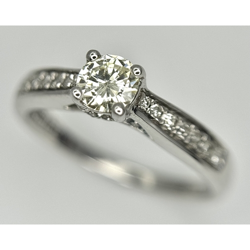 83 - An 18k white gold diamond solitaire with diamond shoulders ring, 0.50ct diamond weight, 2.9g total w... 