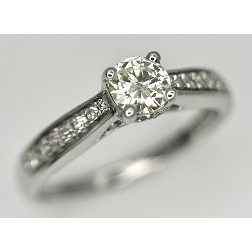 83 - An 18k white gold diamond solitaire with diamond shoulders ring, 0.50ct diamond weight, 2.9g total w... 