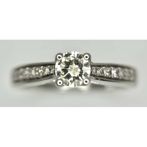 83 - An 18k white gold diamond solitaire with diamond shoulders ring, 0.50ct diamond weight, 2.9g total w... 