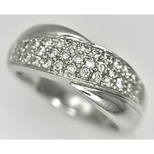 90 - An 18k white gold diamond twist ring, 0.40ct diamond weight, 6.4g total weight, ring size N. SH463I