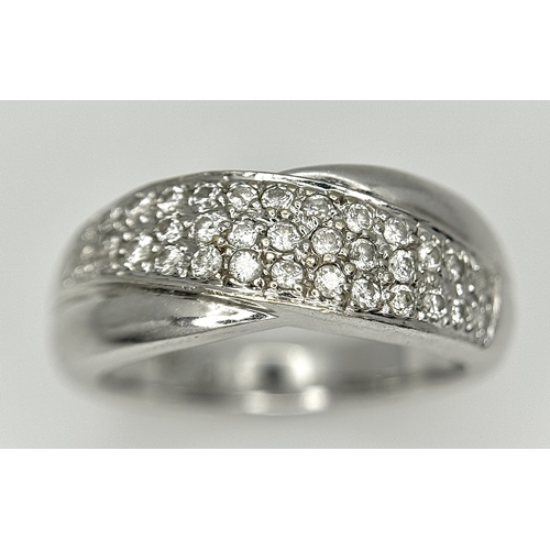 90 - An 18k white gold diamond twist ring, 0.40ct diamond weight, 6.4g total weight, ring size N. SH463I
