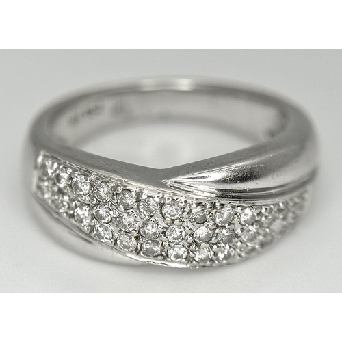 90 - An 18k white gold diamond twist ring, 0.40ct diamond weight, 6.4g total weight, ring size N. SH463I