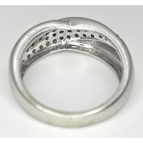 90 - An 18k white gold diamond twist ring, 0.40ct diamond weight, 6.4g total weight, ring size N. SH463I
