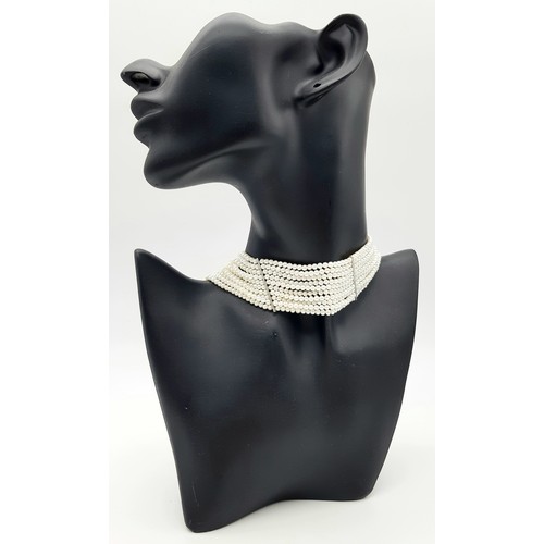 112 - Impressive 10 STRAND, PEARL and SILVER CHOKER NECKLACE. Consisting 10 rows of lab seed pearls with S... 