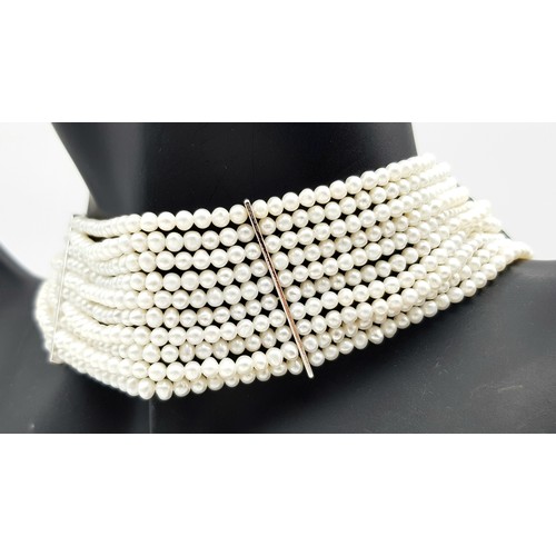 112 - Impressive 10 STRAND, PEARL and SILVER CHOKER NECKLACE. Consisting 10 rows of lab seed pearls with S... 
