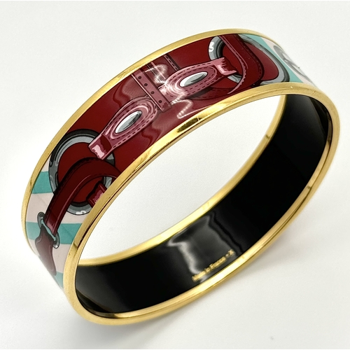 780 - An Hermes Colourful Decorative Enamel and Gilded Metal Bangle. 20mm width. 62mm inner diameter.  Ref... 