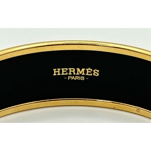 780 - An Hermes Colourful Decorative Enamel and Gilded Metal Bangle. 20mm width. 62mm inner diameter.  Ref... 