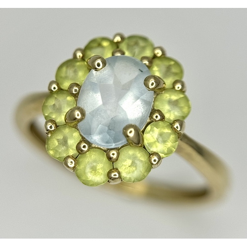 155 - A 9K Yellow Gold Aquamarine and Peridot Ring. Size P 1/2. 2.65g.