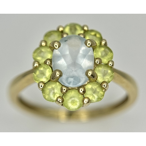 155 - A 9K Yellow Gold Aquamarine and Peridot Ring. Size P 1/2. 2.65g.