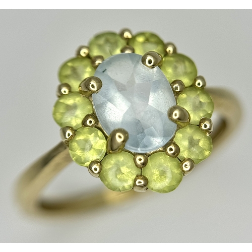 155 - A 9K Yellow Gold Aquamarine and Peridot Ring. Size P 1/2. 2.65g.