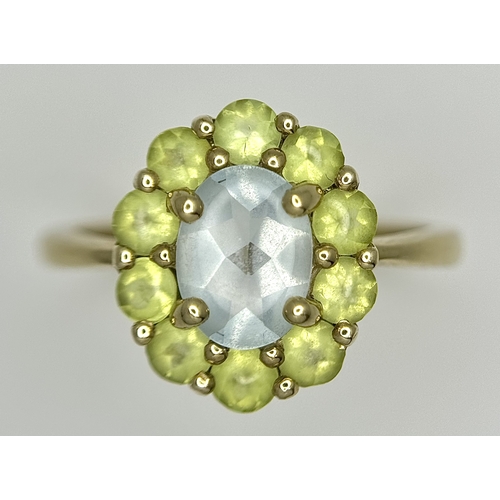 155 - A 9K Yellow Gold Aquamarine and Peridot Ring. Size P 1/2. 2.65g.