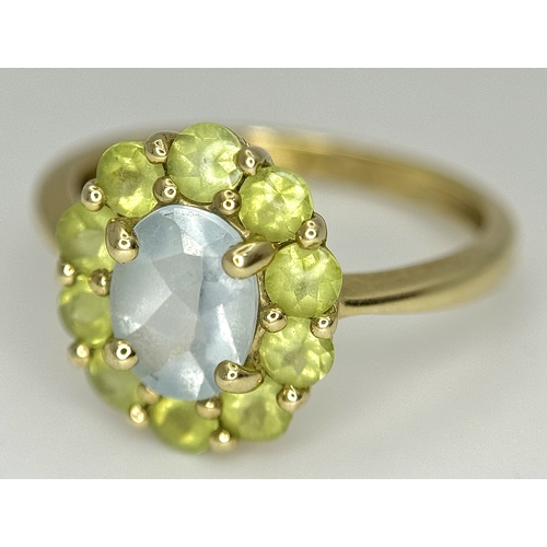155 - A 9K Yellow Gold Aquamarine and Peridot Ring. Size P 1/2. 2.65g.