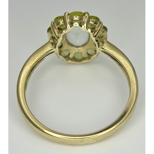 155 - A 9K Yellow Gold Aquamarine and Peridot Ring. Size P 1/2. 2.65g.