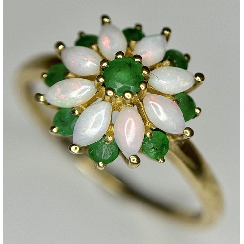 578 - A 9K Yellow Gold Opal and Emerald Ring in Floral Form. Size R. 2.1g.