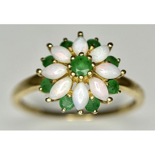 578 - A 9K Yellow Gold Opal and Emerald Ring in Floral Form. Size R. 2.1g.