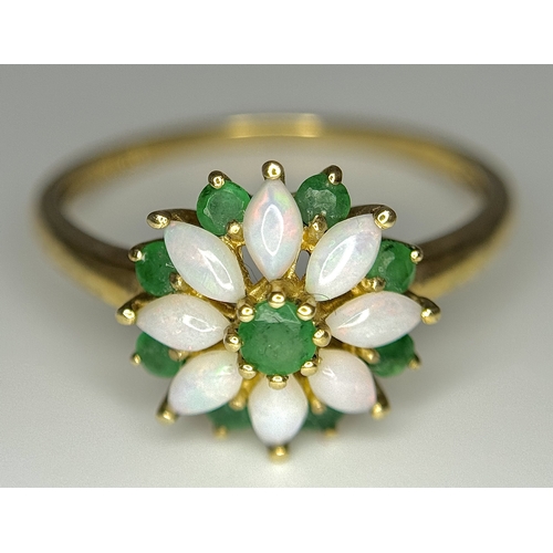 578 - A 9K Yellow Gold Opal and Emerald Ring in Floral Form. Size R. 2.1g.