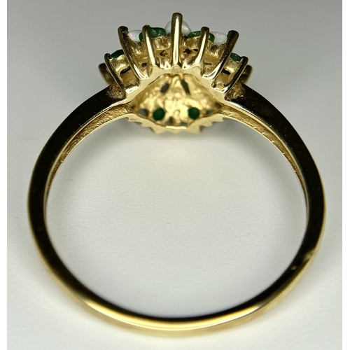 578 - A 9K Yellow Gold Opal and Emerald Ring in Floral Form. Size R. 2.1g.