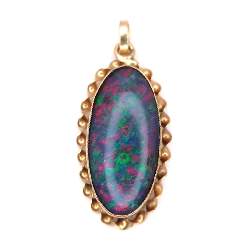 239 - A 9K Yellow Gold Opal Doublet Pendant. Nice colour play. 3cm. 2.1g.