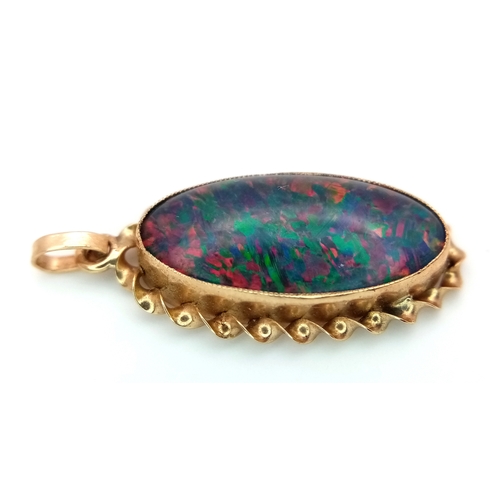 239 - A 9K Yellow Gold Opal Doublet Pendant. Nice colour play. 3cm. 2.1g.