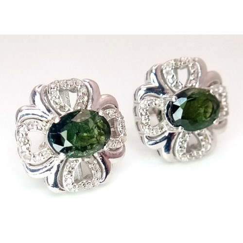 543 - A Pair of Green Sapphire Stud Earrings. Diamond accents. Set in 925 Silver. Comes with a case. CD-19... 