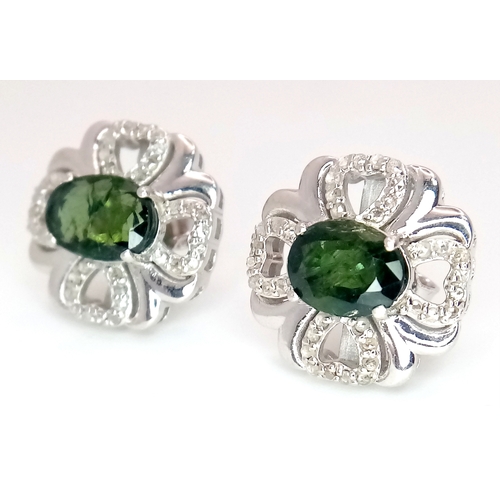 543 - A Pair of Green Sapphire Stud Earrings. Diamond accents. Set in 925 Silver. Comes with a case. CD-19... 