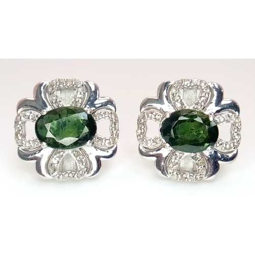 543 - A Pair of Green Sapphire Stud Earrings. Diamond accents. Set in 925 Silver. Comes with a case. CD-19... 