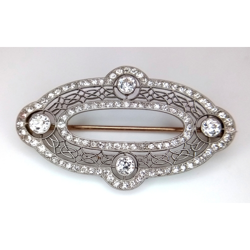 121 - An Art Deco Platinum and Diamond Encrusted Brooch. Four Old European cut diamonds - 0.60ctw with a t... 