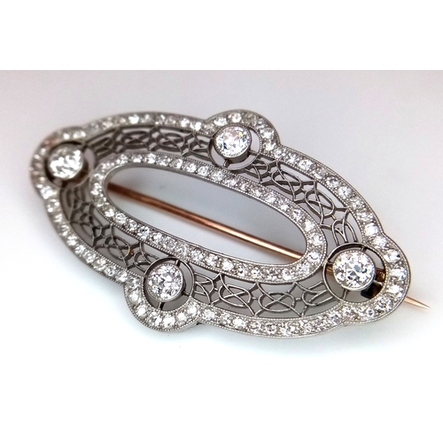 121 - An Art Deco Platinum and Diamond Encrusted Brooch. Four Old European cut diamonds - 0.60ctw with a t... 